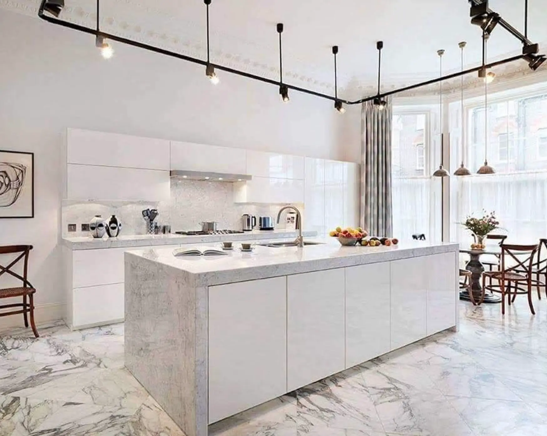 Bright kitchen with marble counters and herringbone tile floor